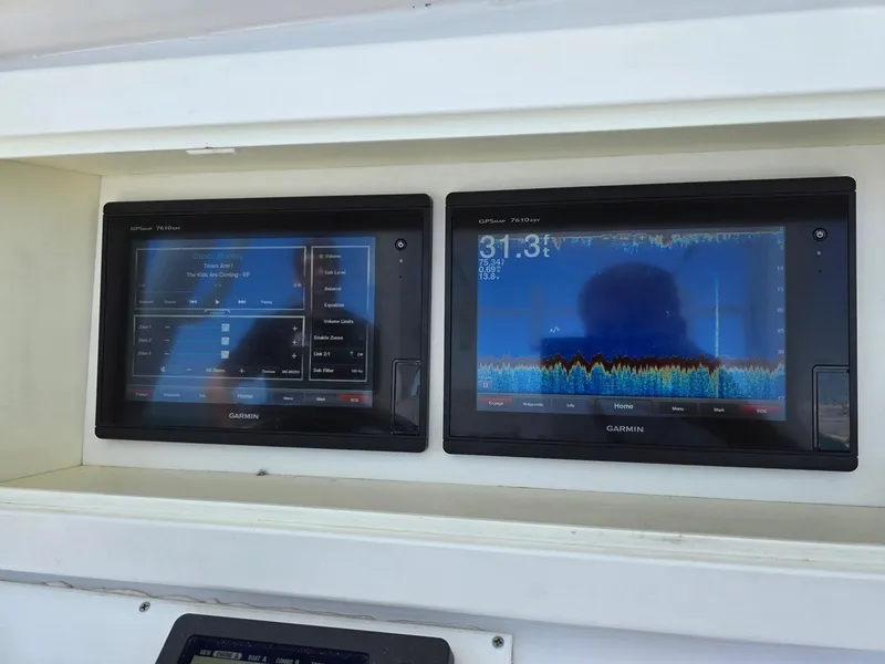Slide: The Image of Garmin marine displays on 2012 Contender Custom 33 Center Console boat dashboard. - 14