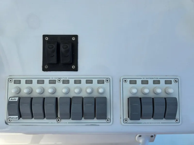 Slide: The Image of Control panel of 2012 Contender Custom 33 Center Console boat with switches and buttons. - 15