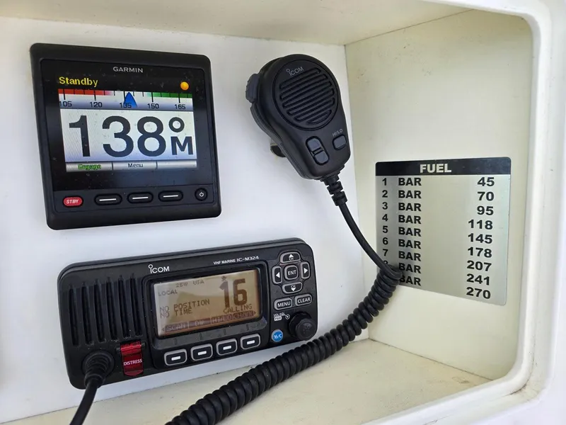 Slide: The Image of 2012 Contender Custom 33 Center Console dashboard with Garmin and Icom marine electronics. - 16