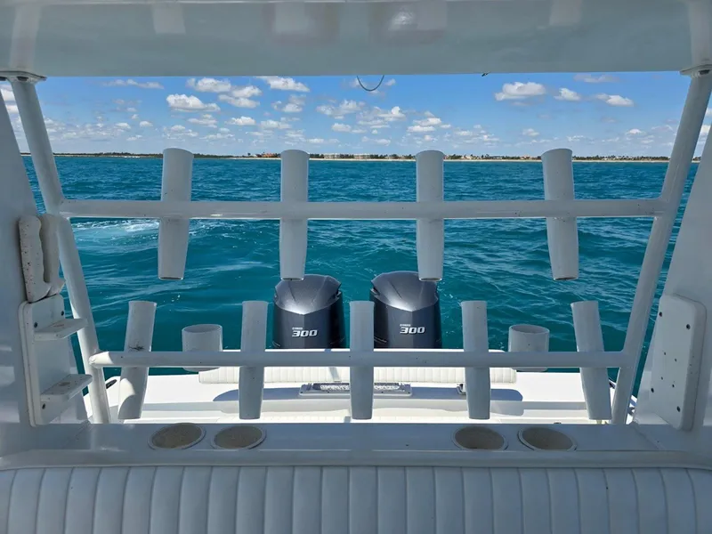 Slide: The Image of 2012 Contender Custom 33 Center Console boat with dual 300 engines on open water. - 19