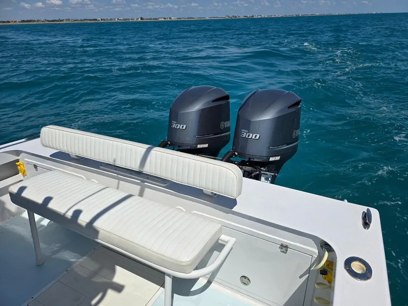 Slide: The Image of 2012 Contender Custom 33 Center Console boat with twin 300 horsepower engines on open water. - 24
