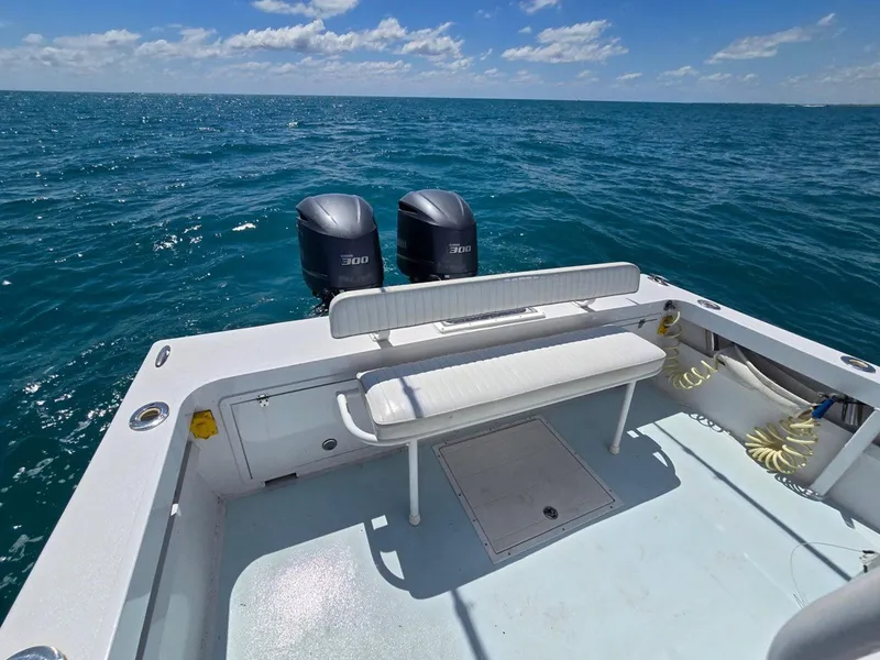 Slide: The Image of 2012 Contender Custom 33 Center Console boat on open sea with twin engines. - 25