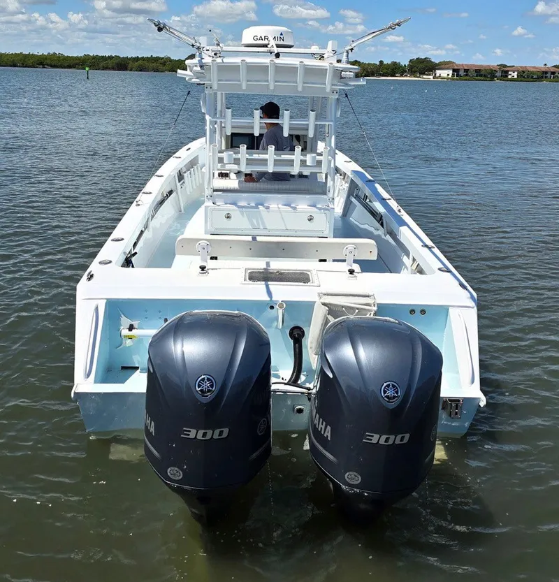 Slide: The Image of 2012 Contender Custom 33 Center Console boat with twin Yamaha 300 engines on the water. - 30