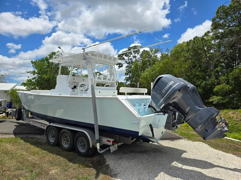Slide: The Image of 2012 Contender Custom 33 Center Console boat on trailer with Yamaha outboard motor. - 31
