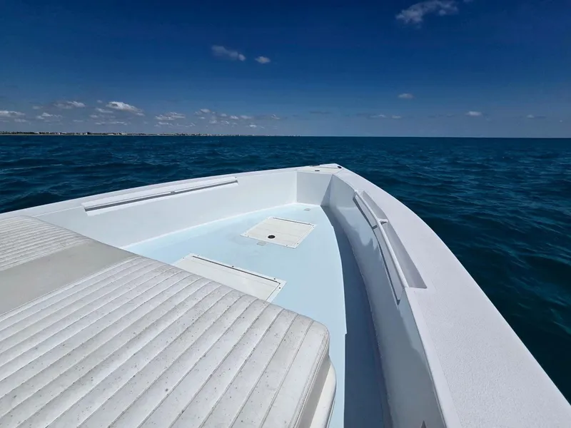 Slide: The Image of 2012 Contender Custom 33 Center Console boat on open ocean under clear blue sky. - 9
