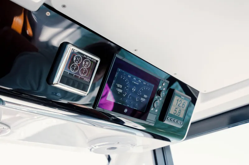 Slide: The Image of 2024 Invincible 46 Pilothouse dashboard with digital displays and controls. - 12