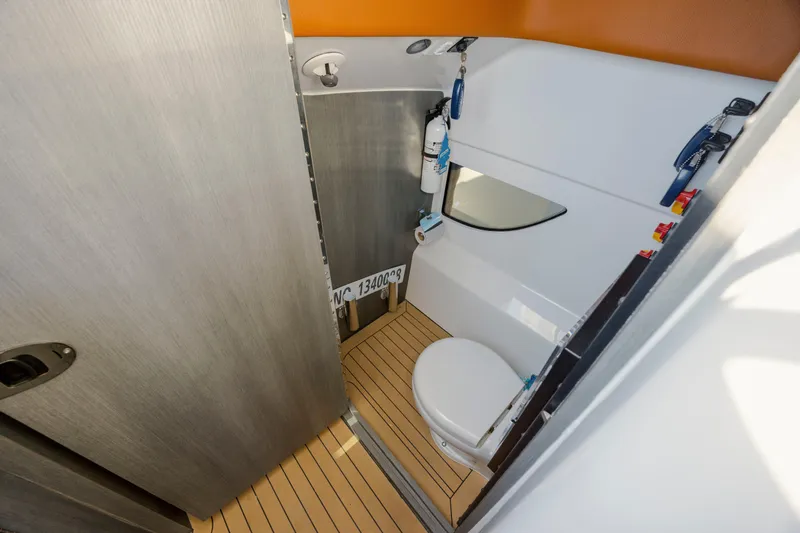 Slide: The Image of 2024 Invincible 46 Pilothouse bathroom with modern fixtures and wooden flooring. - 14