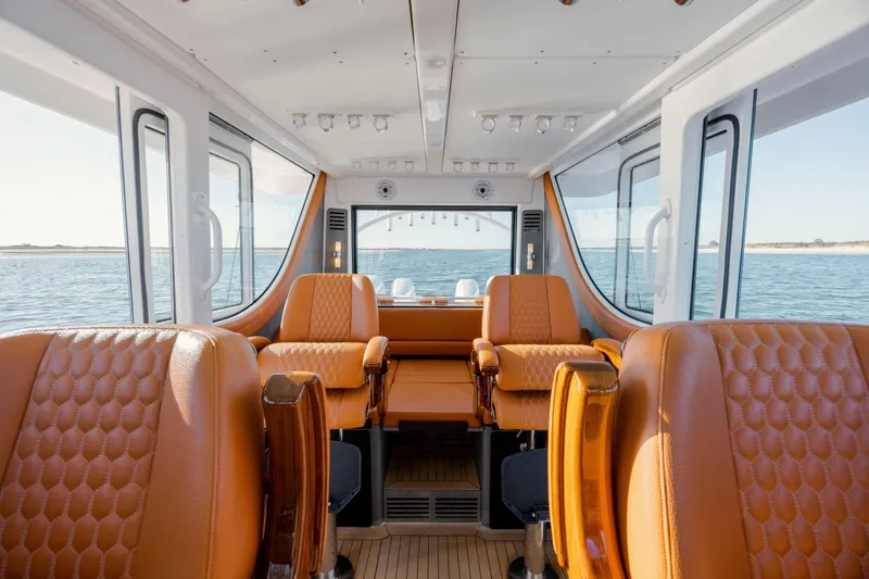 Slide: The Image of Luxurious interior of 2024 Invincible 46 Pilothouse with leather seating and panoramic windows. - 17