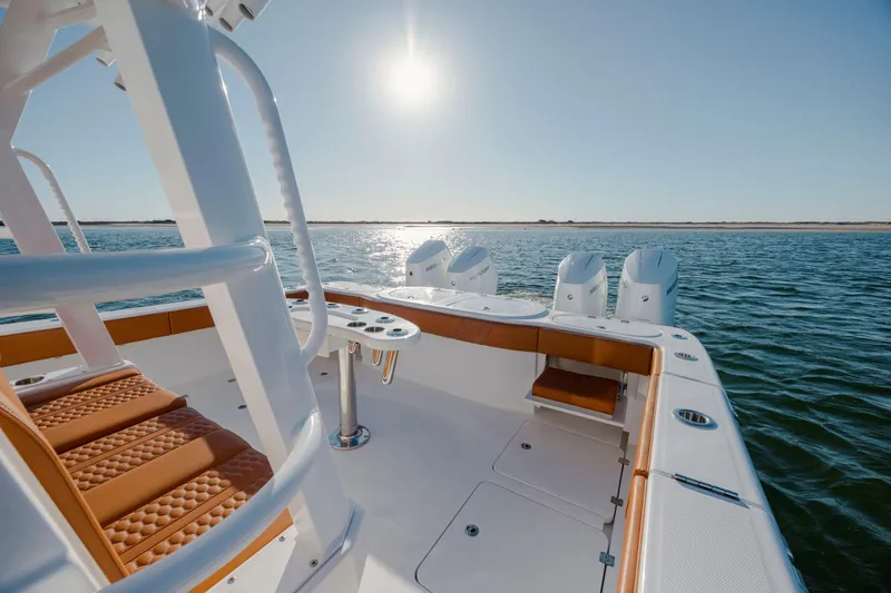 Slide: The Image of 2024 Invincible 46 Pilothouse boat on water, featuring luxurious seating and powerful engines. - 20