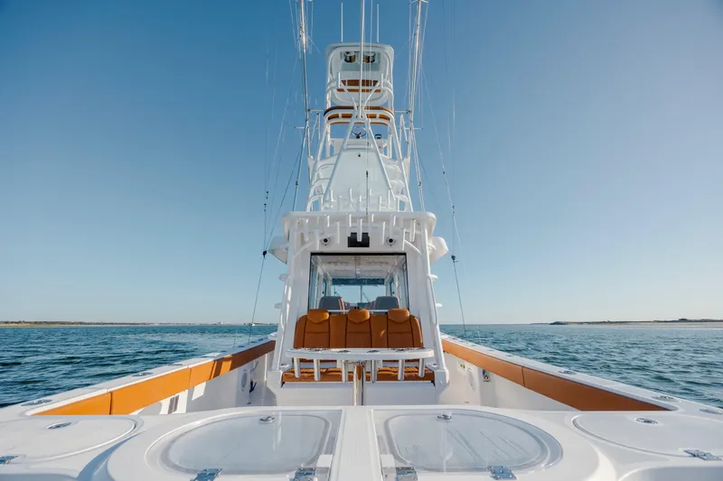 Slide: The Image of 2024 Invincible 46 Pilothouse yacht on open water, showcasing sleek design and luxury features. - 23