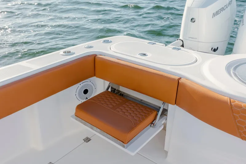 Slide: The Image of 2024 Invincible 46 Pilothouse boat with tan seating and Mercury engines on the water. - 26