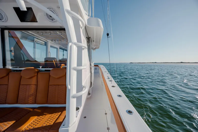 Slide: The Image of 2024 Invincible 46 Pilothouse yacht with luxurious seating, cruising on open water. - 29