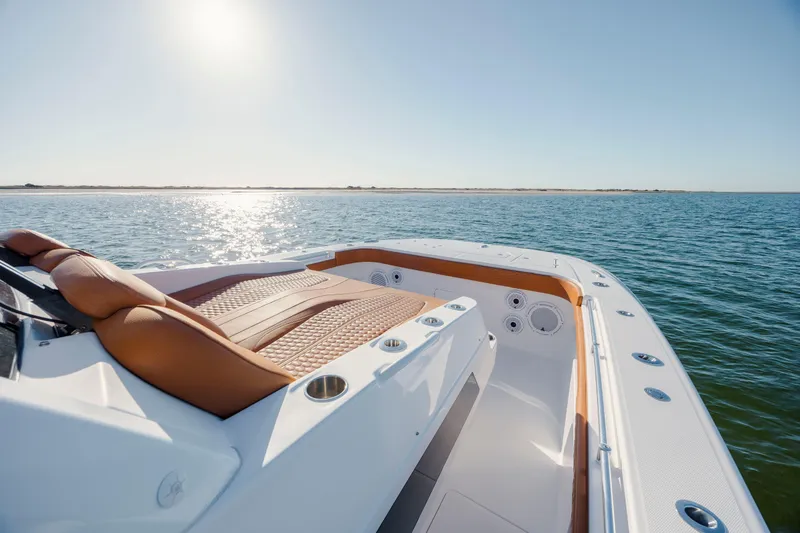 Slide: The Image of 2024 Invincible 46 Pilothouse boat on calm ocean waters under clear sky. - 31