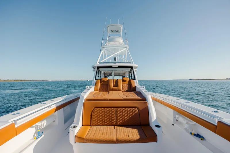 Slide: The Image of 2024 Invincible 46 Pilothouse boat on open water, featuring luxurious seating and sleek design. - 33