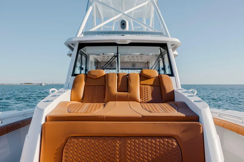 Slide: The Image of 2024 Invincible 46 Pilothouse boat with luxurious seating on open water. - 34