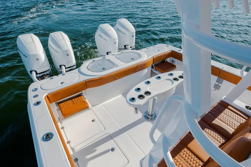 Slide: The Image of 2024 Invincible 46 Pilothouse boat with quad Mercury engines on open water. - 38