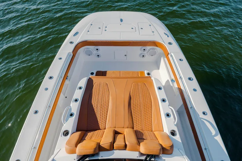 Slide: The Image of Luxurious seating on 2024 Invincible 46 Pilothouse boat, surrounded by water. - 40