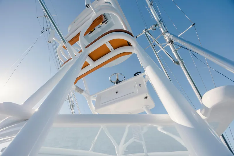 Slide: The Image of 2024 Invincible 46 Pilothouse tower view against clear blue sky. - 44
