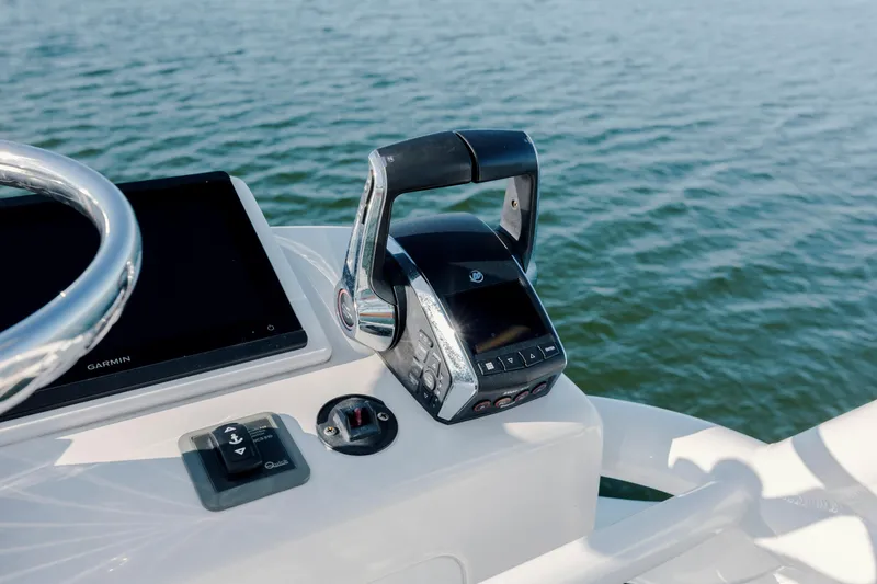 Slide: The Image of Control panel of 2024 Invincible 46 Pilothouse boat with Garmin display on water. - 46