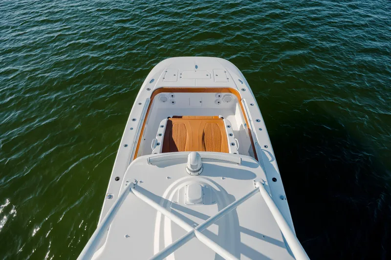 Slide: The Image of 2024 Invincible 46 Pilothouse boat deck on calm water. - 50