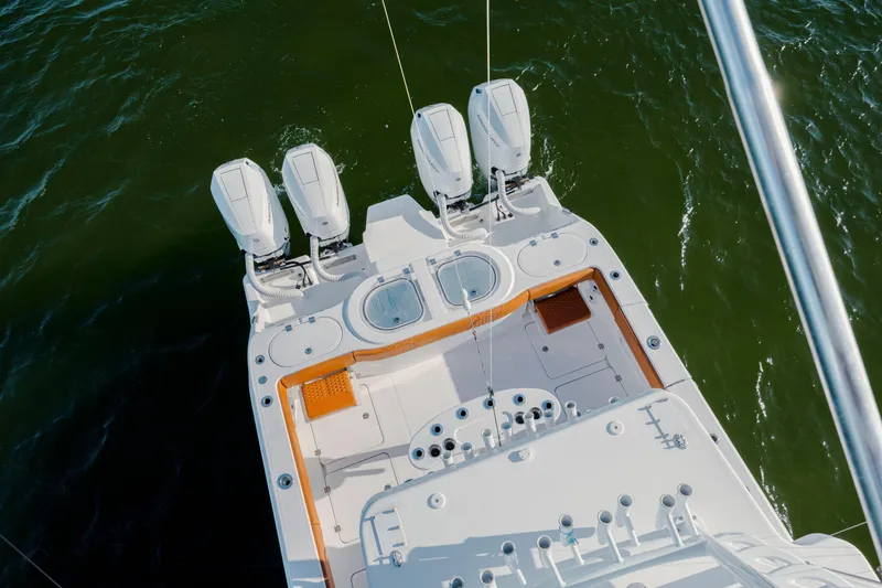 Slide: The Image of 2024 Invincible 46 Pilothouse boat with four powerful engines on open water. - 51