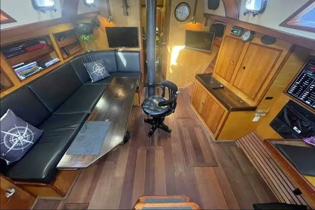 Slide: The Image of Interior of 1992 Bruce Bingham Custom 47 yacht with wood finish and black seating. - 12