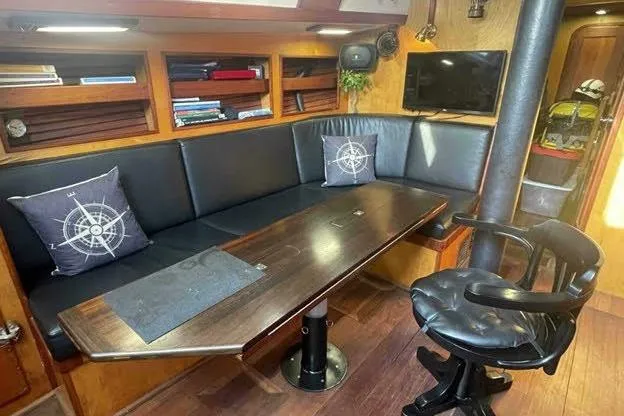 Slide: The Image of Interior of 1992 Bruce Bingham Custom 47 yacht with leather seating and nautical decor. - 13