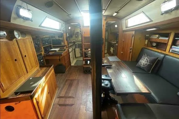 Slide: The Image of Interior of 1992 Bruce Bingham Custom 47 Steel Hull yacht, featuring wood finishes and seating area. - 18