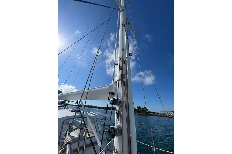 Slide: The Image of Sailboat mast and rigging on 1992 Bruce Bingham Custom Steel Hull 47 under clear blue sky. - 37