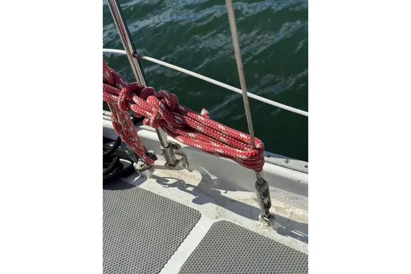 Slide: The Image of Red rope on Bruce Bingham Custom Steel Hull 47 sailboat, 1992, with ocean background. - 50
