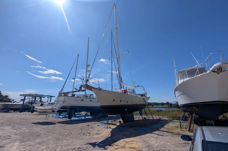 Slide: The Image of Bruce Bingham Custom 47 Steel Hull 1992 sailboat in dry dock under clear blue sky. - 6