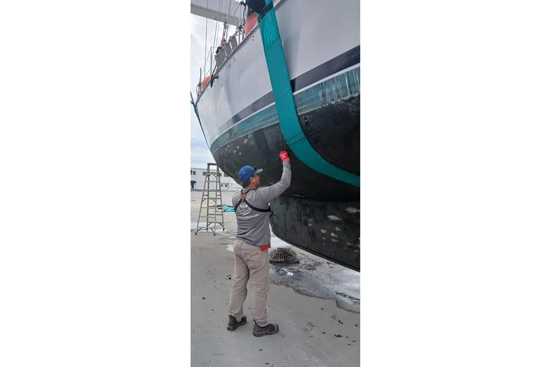 Slide: The Image of Person inspecting Bruce Bingham Custom 47 Steel Hull boat, 1992 model, in a shipyard. - 8