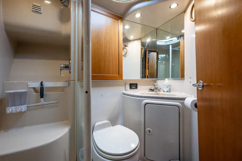 Slide: The Image of Luxurious bathroom in 2004 Riviera 37 Flybridge yacht with modern fixtures and wood accents. - 10