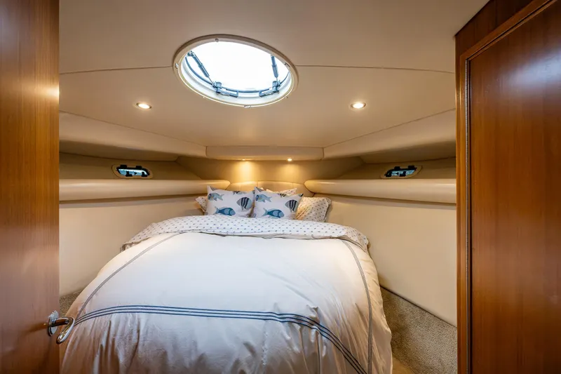 Slide: The Image of Luxurious bedroom interior of 2004 Riviera 37 Flybridge yacht with cozy bedding. - 11