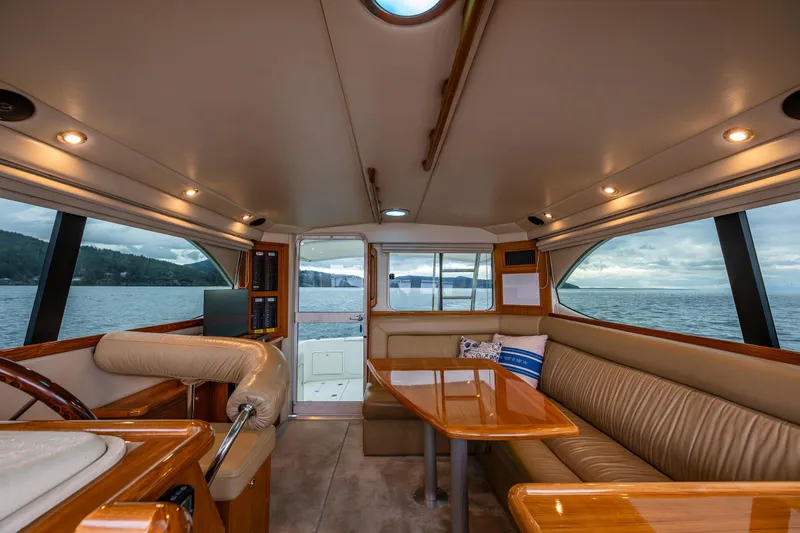 Slide: The Image of Interior of 2004 Riviera 37 Flybridge yacht with elegant seating and ocean view. - 16