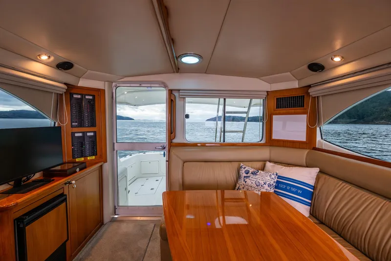 Slide: The Image of Interior of 2004 Riviera 37 Flybridge yacht with elegant seating and scenic ocean view. - 18