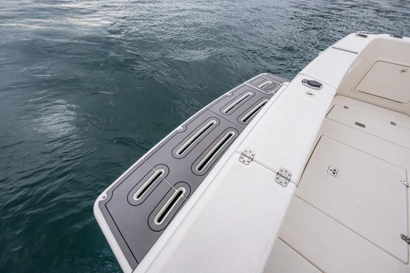 Slide: The Image of 2004 Riviera 37 Flybridge swim platform and deck detail on water. - 21