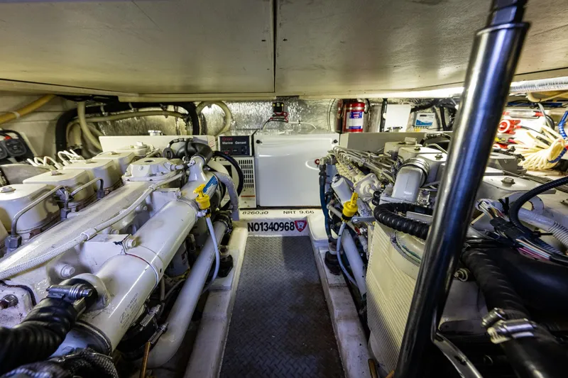 Slide: The Image of Engine room of 2004 Riviera 37 Flybridge yacht, showcasing dual engines and equipment. - 25