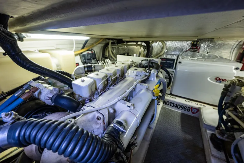 Slide: The Image of Engine room of 2004 Riviera 37 Flybridge yacht, showcasing mechanical components and equipment. - 26