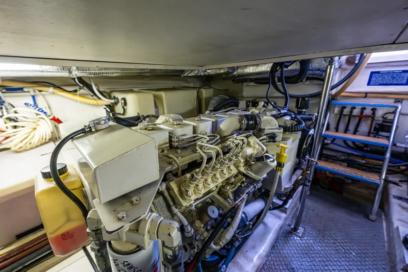 Slide: The Image of Engine room of 2004 Riviera 37 Flybridge yacht, showcasing detailed machinery and components. - 30