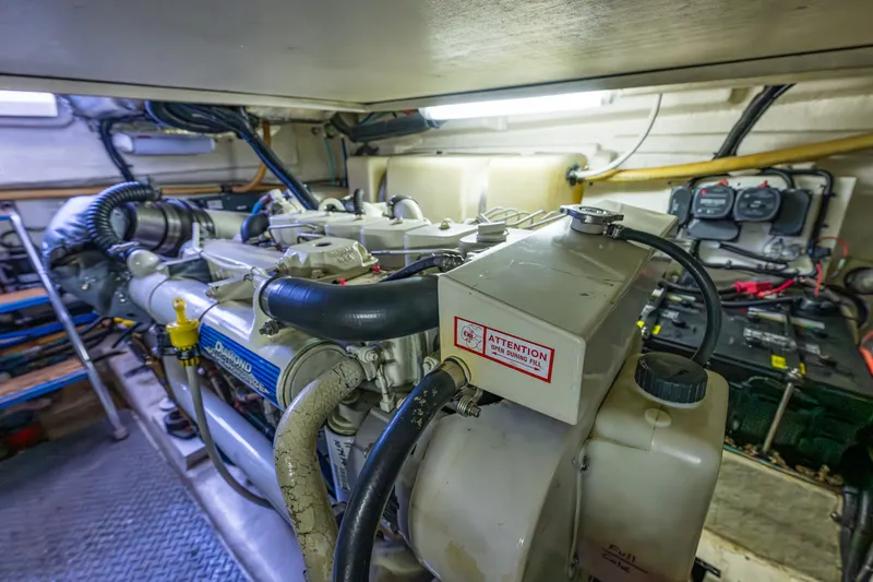 Slide: The Image of Engine room of 2004 Riviera 37 Flybridge yacht, showcasing mechanical components and wiring. - 31