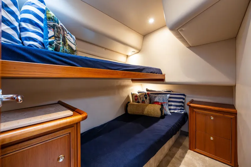 Slide: The Image of Cozy cabin interior of 2004 Riviera 37 Flybridge with bunk beds and nautical decor. - 9