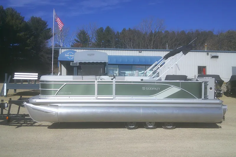 The Image of 2026 Godfrey Sweetwater 2286 FS pontoon boat parked outdoors on a sunny day. - 1