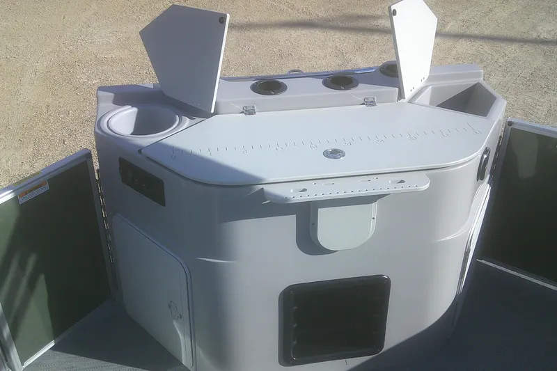 Slide: The Image of 2026 Godfrey Sweetwater 2286 FS boat console with storage compartments and cup holders. - 11