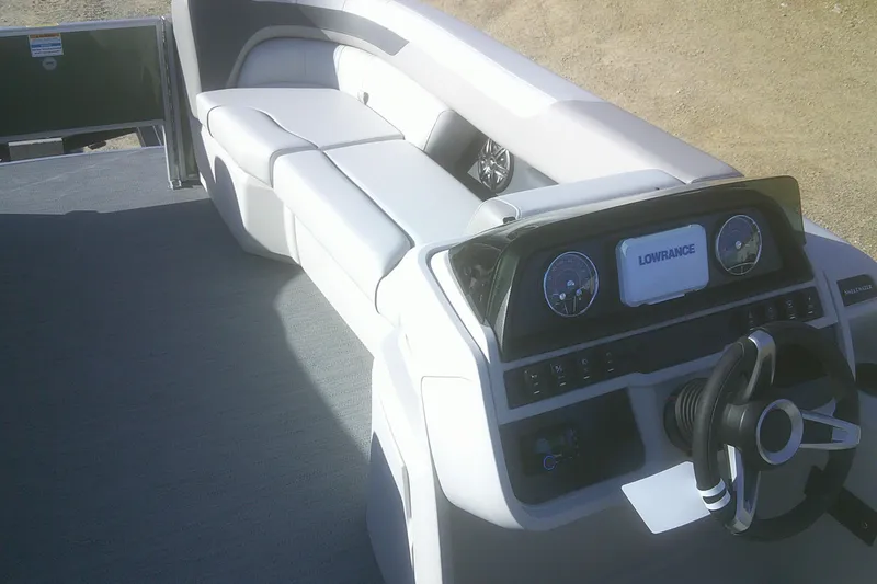 Slide: The Image of 2026 Godfrey Sweetwater 2286 FS boat interior with steering console and seating. - 14