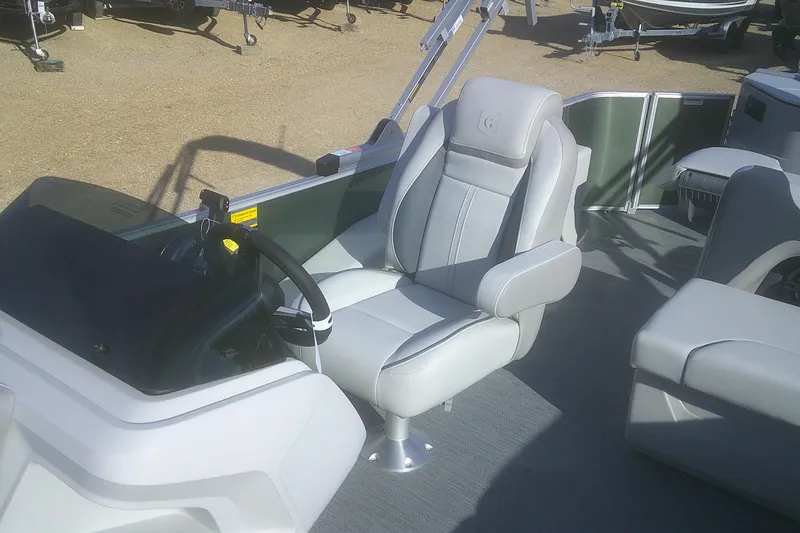 Slide: The Image of 2026 Godfrey Sweetwater 2286 FS boat interior with captain's chair and steering console. - 5