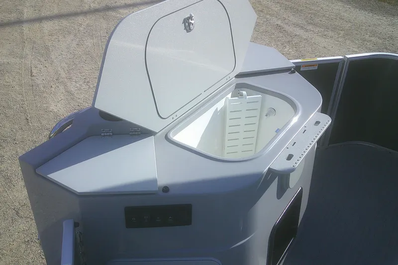 Slide: The Image of 2026 Godfrey Sweetwater 2286 FS boat storage compartment with open lid, showing interior details. - 9