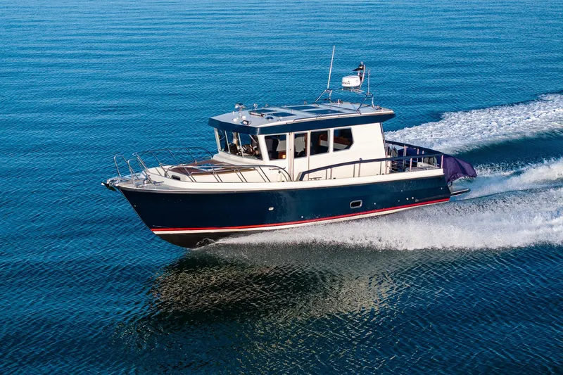 The Image of 2019 Targa 32 boat cruising on clear blue water. - 0