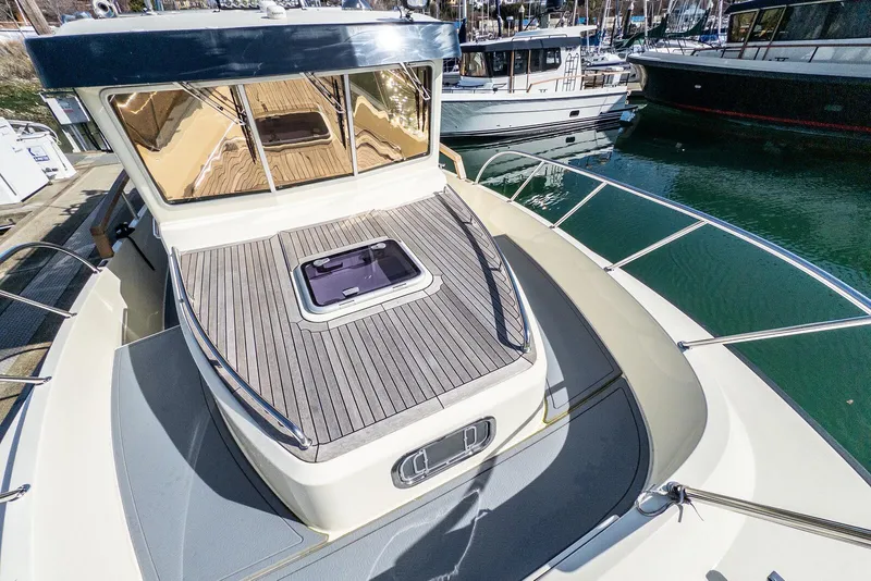 Slide: The Image of 2019 Targa 32 boat with sleek deck design, docked in a marina. - 10