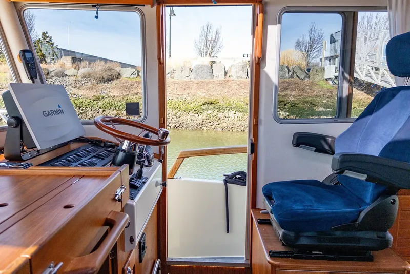 Slide: The Image of Interior of 2019 Targa 32 boat with Garmin navigation system and blue captain's chair. - 17